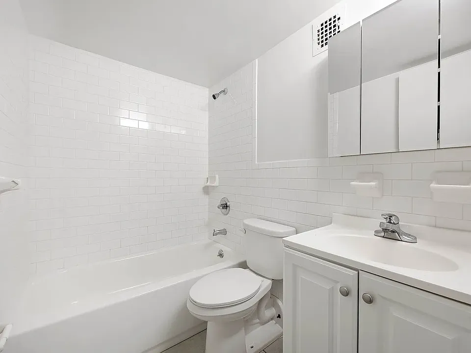 Clean and fully furnished bathroom with modern fixtures and a fresh, inviting design.