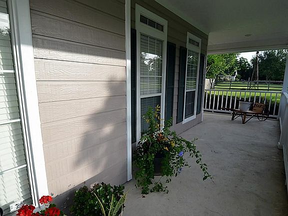 A view of the great from porch which wraps around both sides of the home.