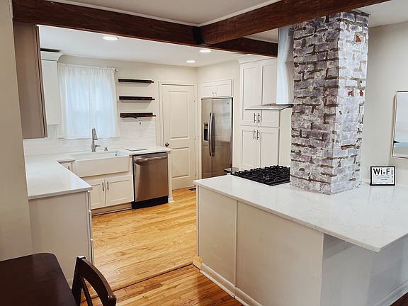 Newly installed cabinets and built in dishwasher and fridge. Beautiful farmhouse sink.