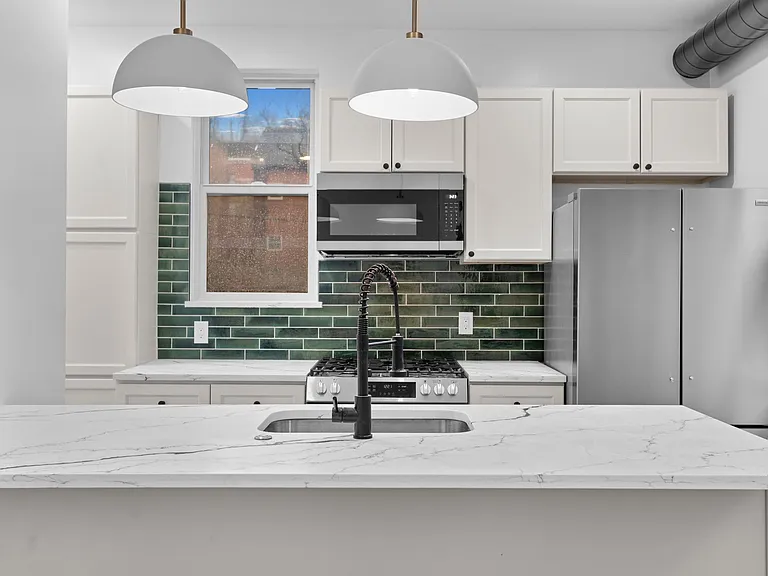 Brand new kitchen with quartz peninsula and stainless steel appliances