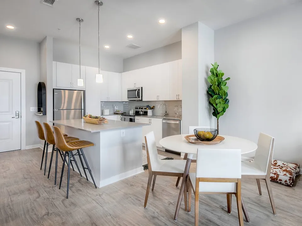 Scheme 1 kitchen with quartz countertops, tile backsplash, stainless steel appliances and hard surface flooring