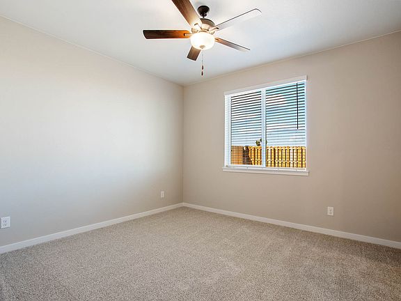 The master bedroom is spacious with a large window.