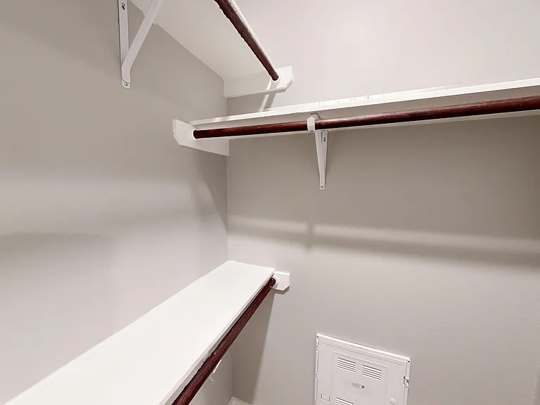 The primary bedroom in Sling Station includes a deep closet with custom shelving. The primary bedroom in Sling Station includes a deep closet with custom shelving.
