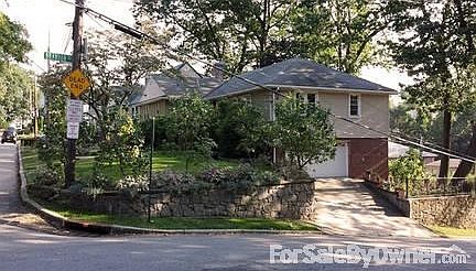 Large Raised Ranch Home on 2 lots
						:
						3/4 view of house showing 2 car garage