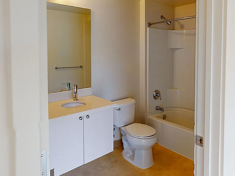 Apartment Bathroom with wood-style flooring.