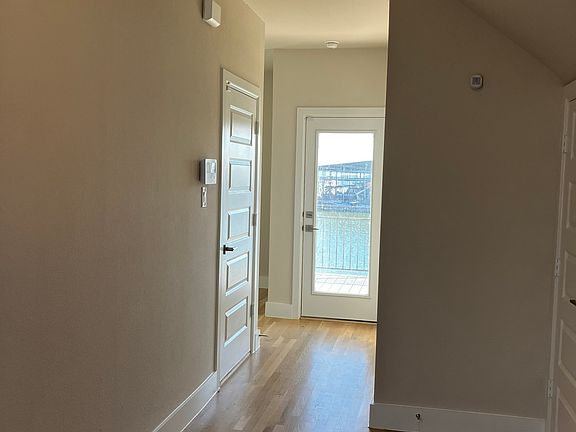 entry: under stairs storage, full bathroom, flex space, garage entry and full deck, lake-facing