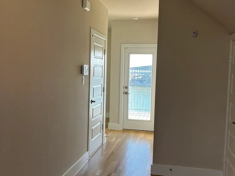 entry: under stairs storage, full bathroom, flex space, garage entry and full deck, lake-facing
