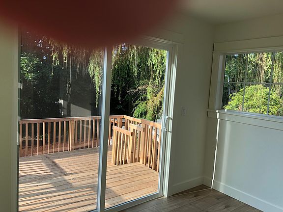 Deck. Weeping willow in fenced backyard