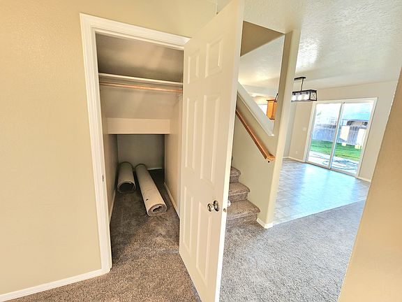Under stair storage and coat closet off front room