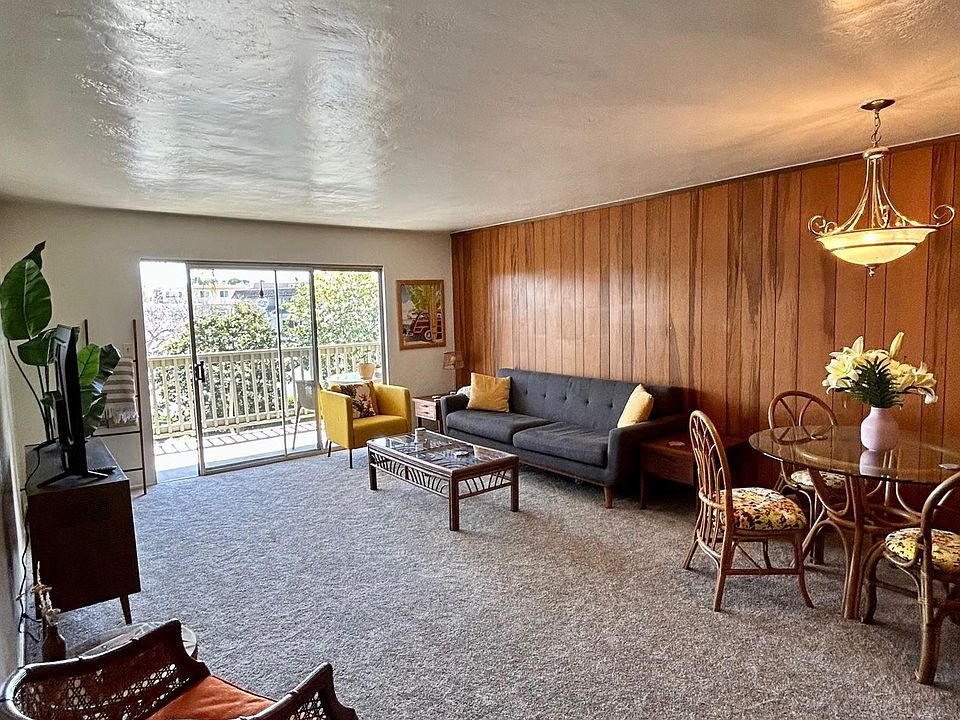 Spacious living room with original wood paneling