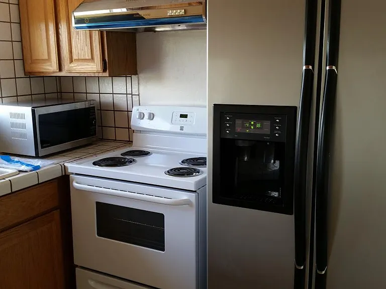 Kitchen with stove, refrigerator, and microwave