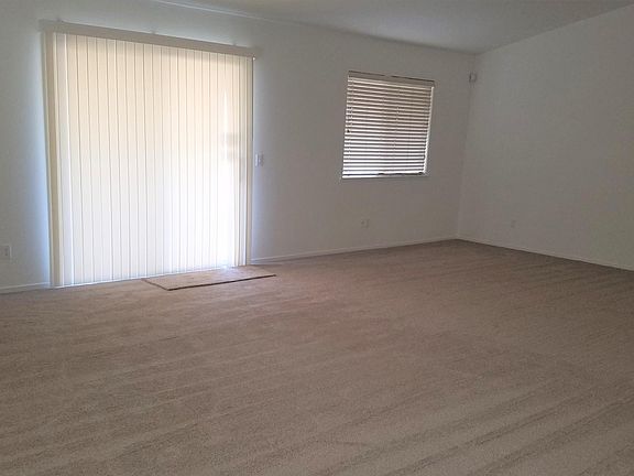 Large family room with gas fireplace and wall-to-wall carpet