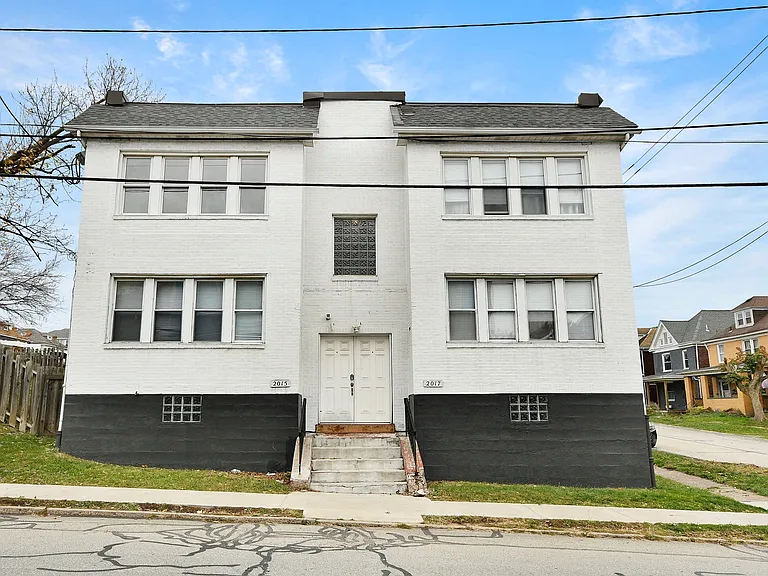Exterior of building; unit is top left.