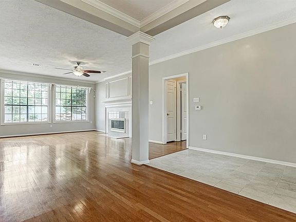 View From Formal Dining Room To The Living Room & Wall Of Windows Looking Out Onto Pool & Back Yard.