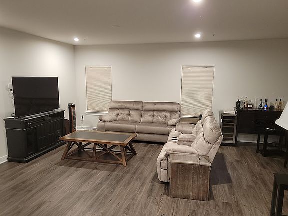 'Great room' used as a living room and dining room. Living room view.