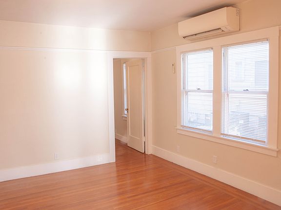 dining room looking towards side window and towards bedroom. Mini-split heating and air unit is over windows