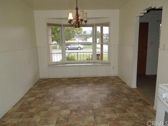 Kitchen eating area with bay window and storage underneath window.