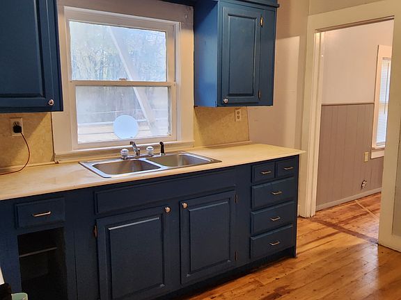 Kitchen has refrigerator, microwave and gas stove.