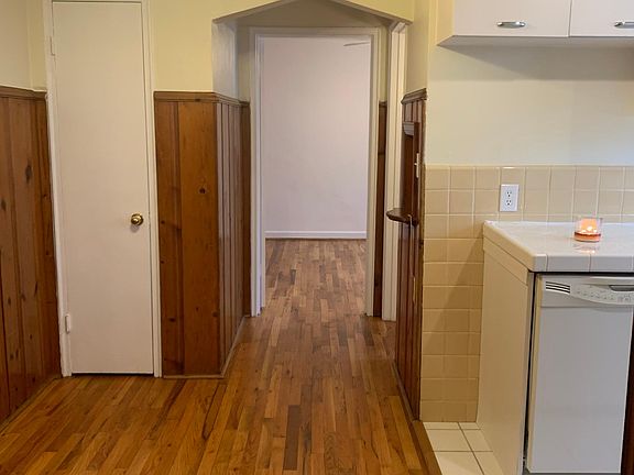 looking from family room to bedroom with kitchen on right and dinette on left