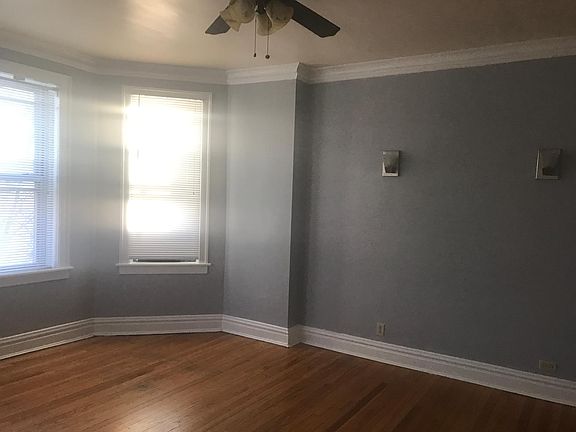 Sunny bright living room with ceiling fans