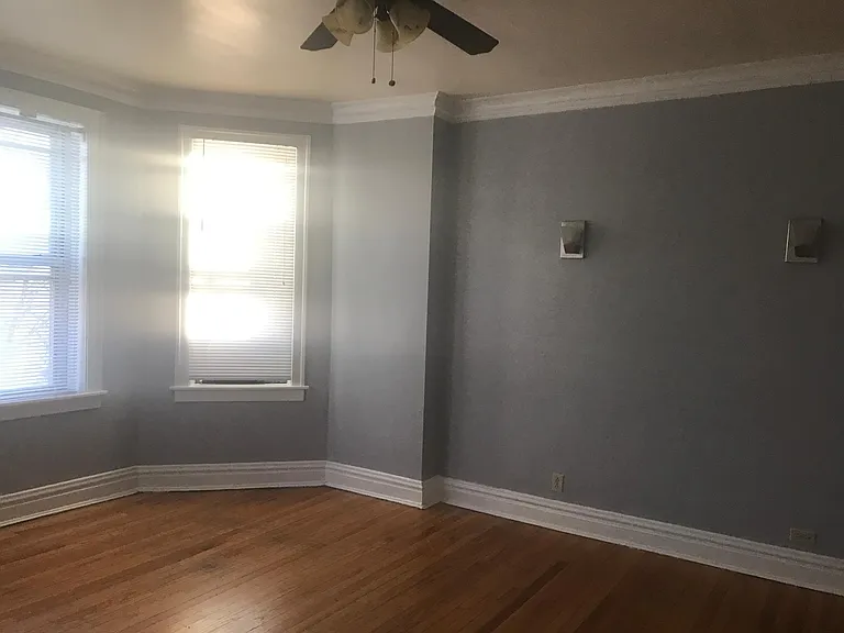Sunny bright living room with ceiling fans