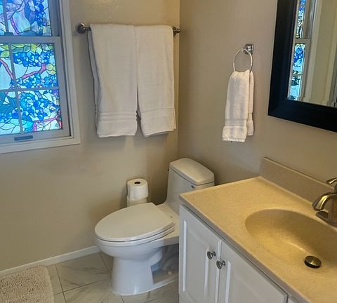 Bathroom with window, vanity and mirror