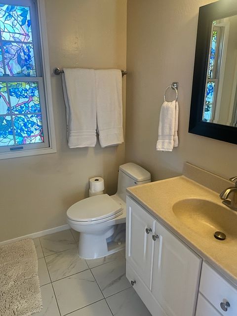 Bathroom with window, vanity and mirror