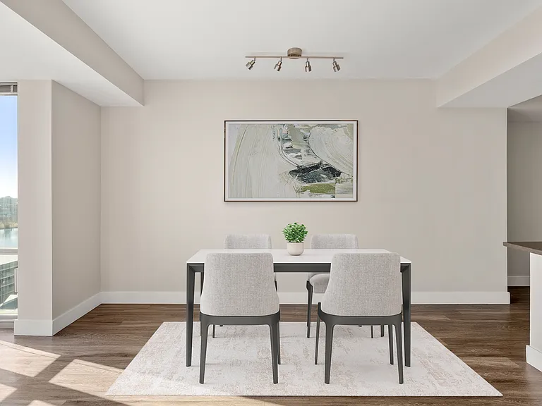 Your dining space offers the perfect blend of comfort and sophistication, framed by high ceilings and contemporary finishes