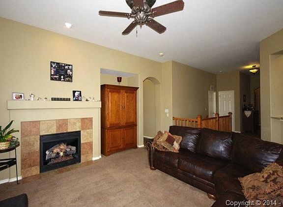 Living room with gas fireplace for cold winters and ceiling fan for those warm summers