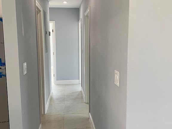Hallway leads to 3 bedrooms and 2 baths