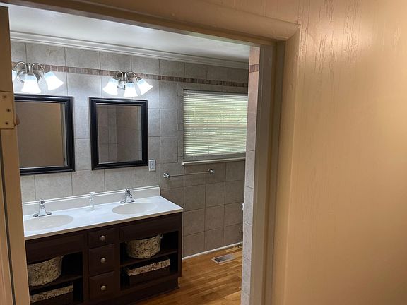 Master bathroom from hallway. Double vanity with two closets, Tub/Shower combination and instant hotwater to sinks.
