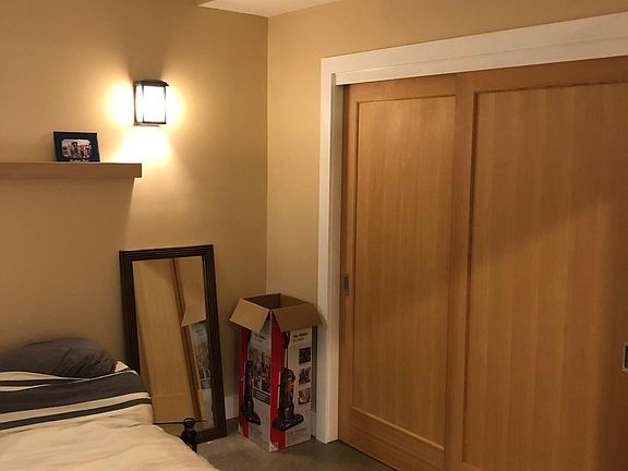 Bedroom with sliding closet doors, ceiling fan