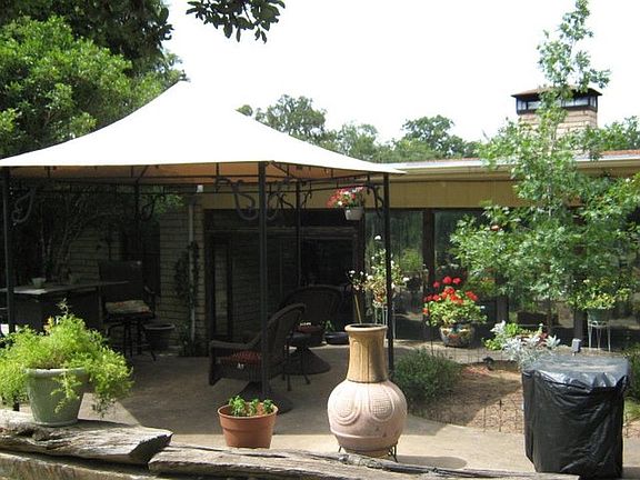 Backyard patio, former tenants cover not on property now