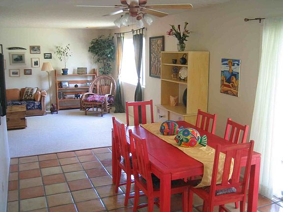 Open floor plan with tile in entry, dining/kitchen, and baths.