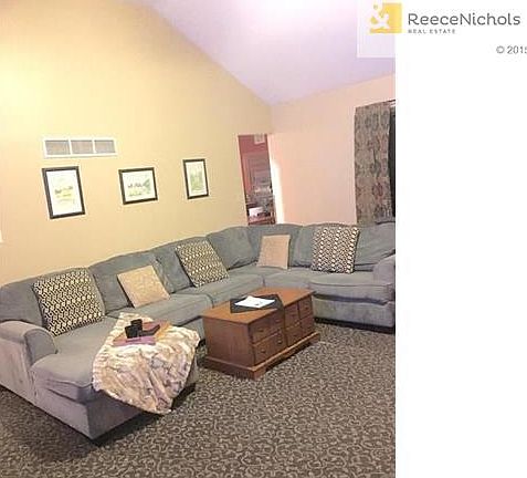 Living room is large and has vaulted ceiling with new paint