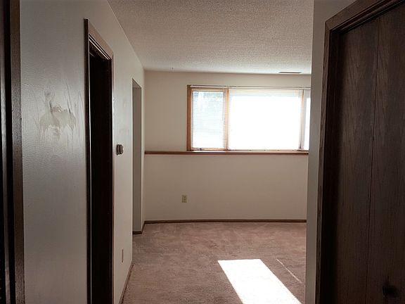 Standing at bottom of stairs, looking towards living room