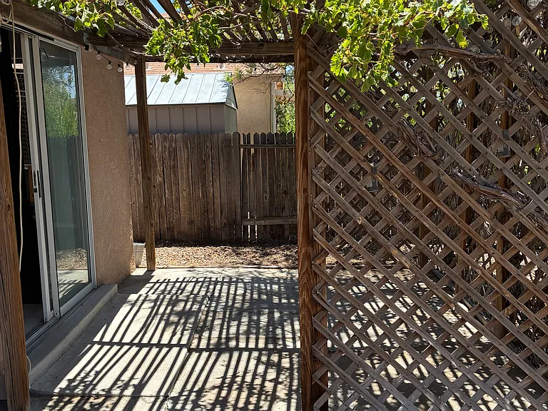 Back yard sitting area, covered in grape vines off the family room through sliding glass doors