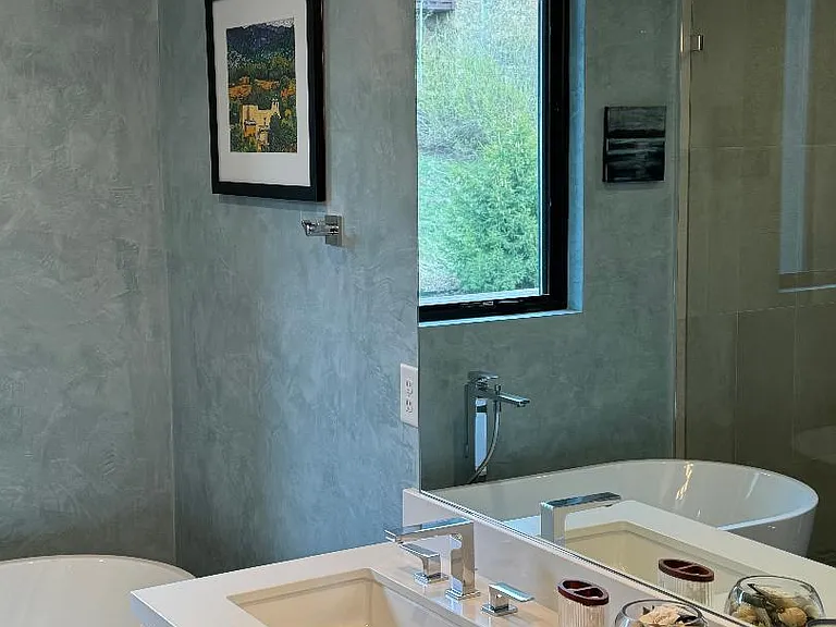 double sink vanity in master bathroom painted in sky blue Venetian plaster