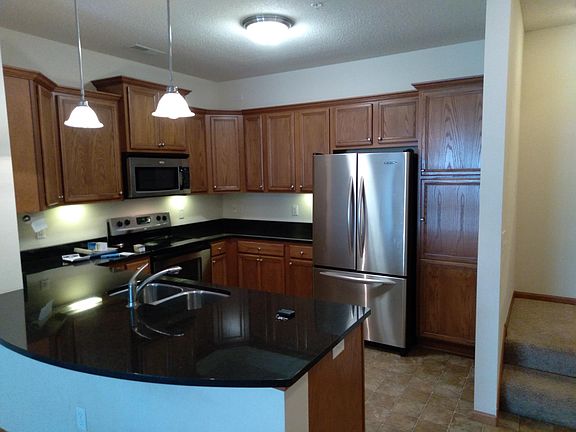 Stainless steel appliances, KitchenAid fridge, and granite counters!