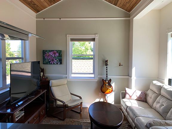 Den. 14-foot ceilings and ceiling fan