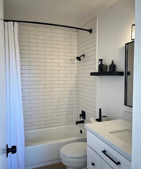 Gorgeous newly renovated upstairs bathroom featuring floor to ceiling subway tiles in bath/shower combo, quartz countertops, soft close cabinets and all new fixtures