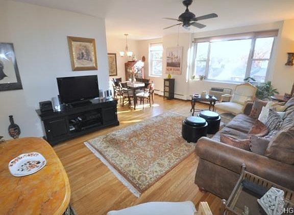 Sunny living room opens to the "L" shape dining room has eastern views and refinished hardwood floor