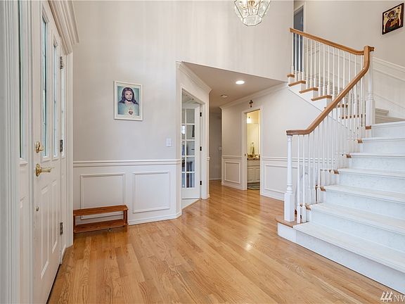 The entry features hardwood and a staircase featuring Italian slab marble-and there are 2 seperate staircases to access the second floor.