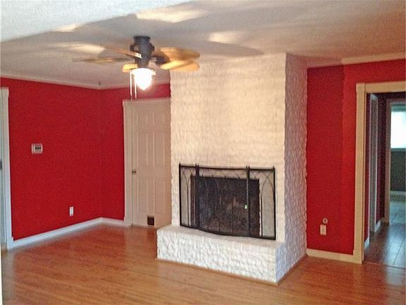 Family Room features pretty laminate wood flooring, cozy fireplace and views of the lake.