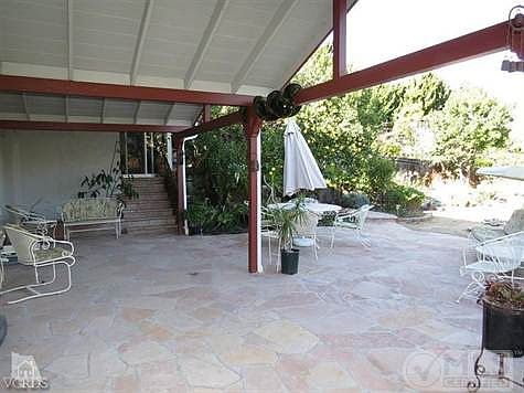 Covered patio with custom concrete and vaulted lanai.