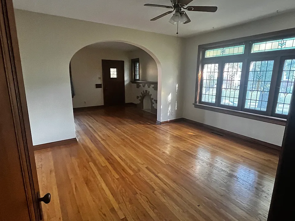 Large, bright dining room with more original stained glass.