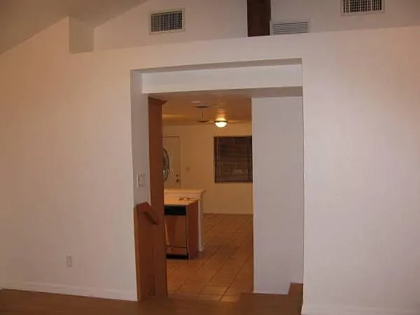 View from living room down a few steps into the kitchen/dining