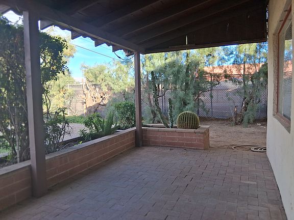 Brick paver front porch with planter.