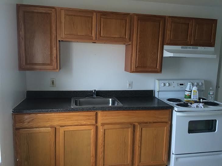Spacious kitchen, with fridge and stove.