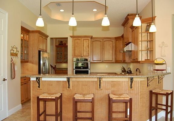 chef's kitchen with cust. cabinetry, solid surface tops and decorative ceiling